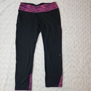 Road Runner Sports size small running capris with pink space dye accents